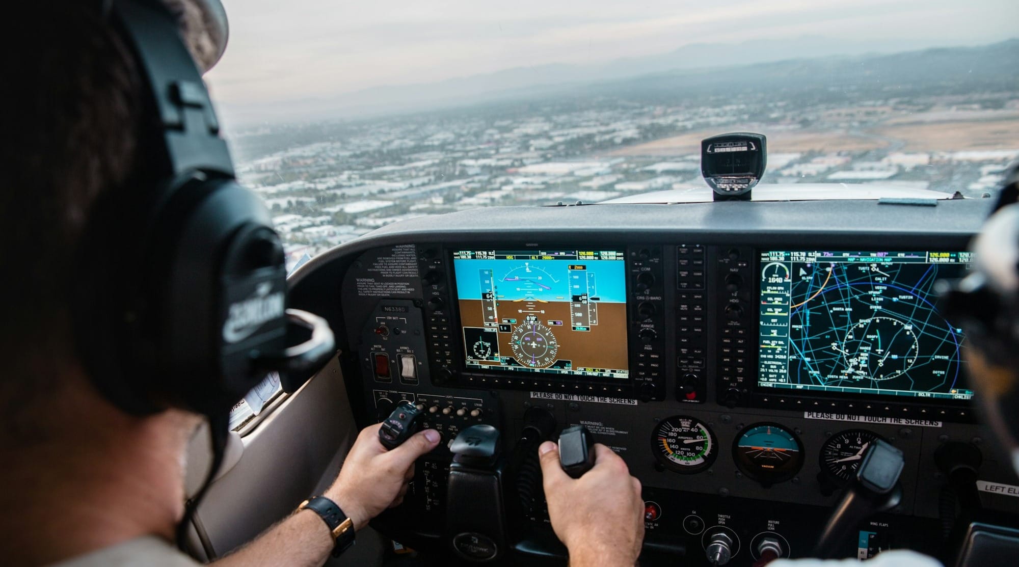 man flying aircraft under cloudy sky