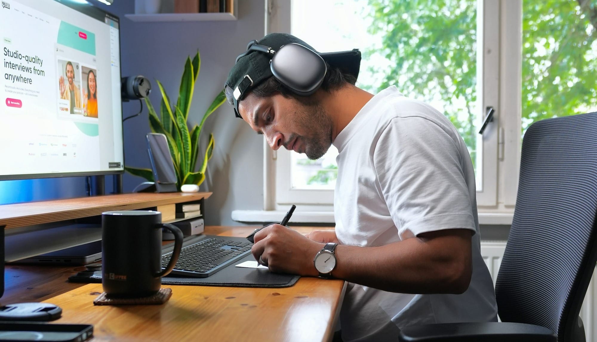 a man sitting at a desk working on a laptop